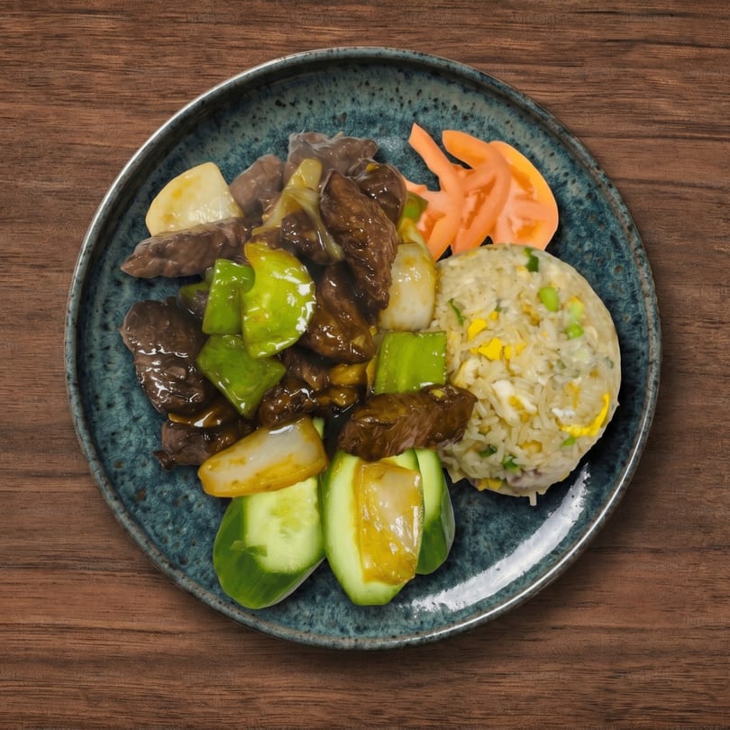 Beef and peppers with fried rice, pickled ginger, and cucumber on a blue plate.